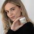Woman holding the REJUVENATE BRIGHTENING ENZYME MASQUE 50ML