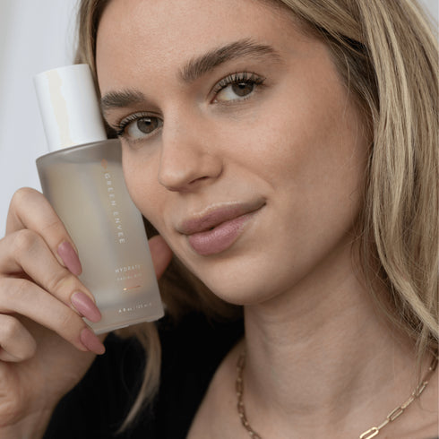 Woman with Green Envee Hydrate Facial Mist